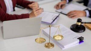 Golden scales of justice with legal documents and laptop representing administrative review UK visa 2025 challenge procedures
