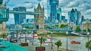 Tower Bridge and London financial district skyline representing why invest in the UK opportunities combining heritage stability with modern finance