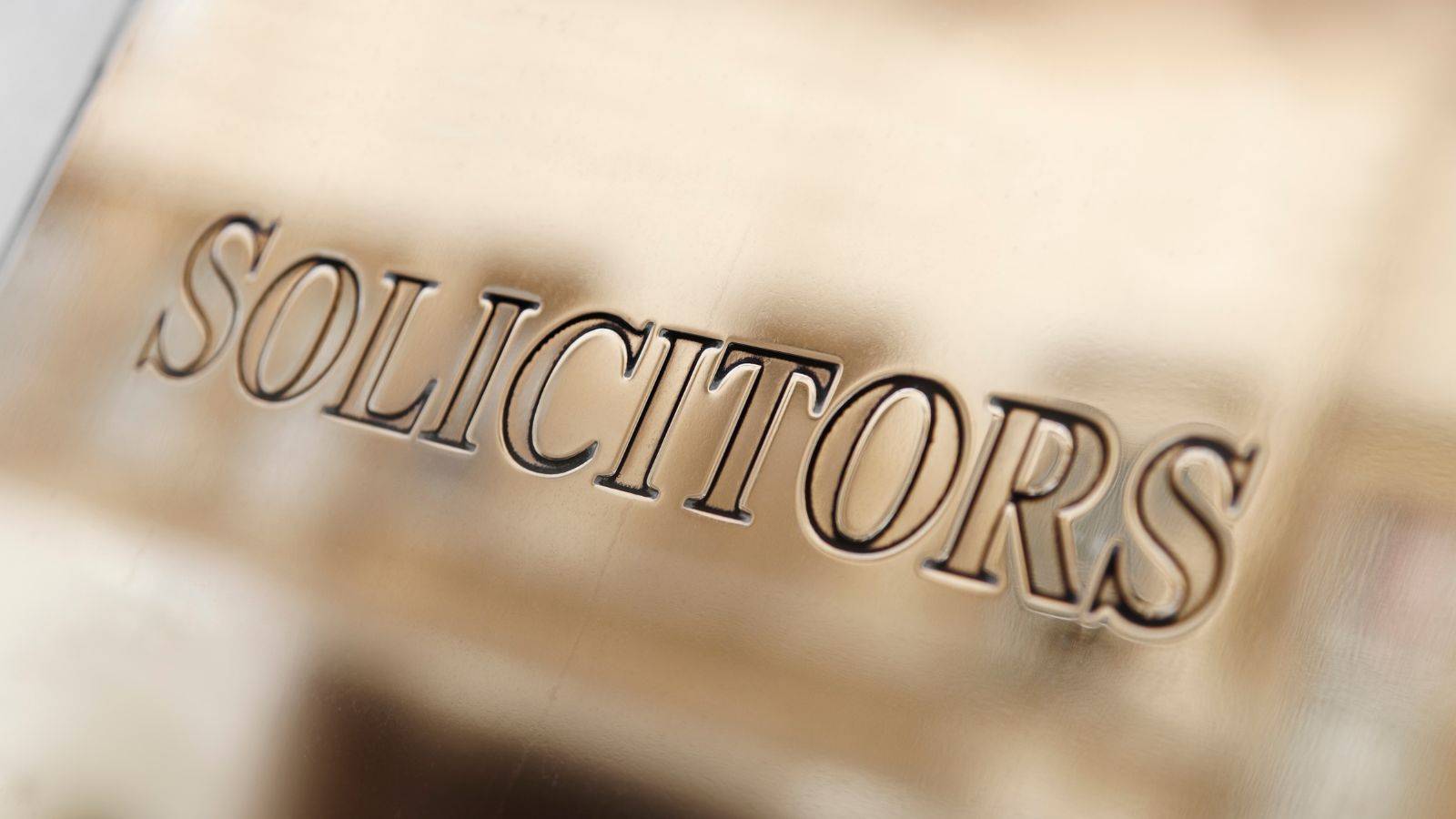 Sign Displaying The Word Solicitors On A Brass Legal Nameplate