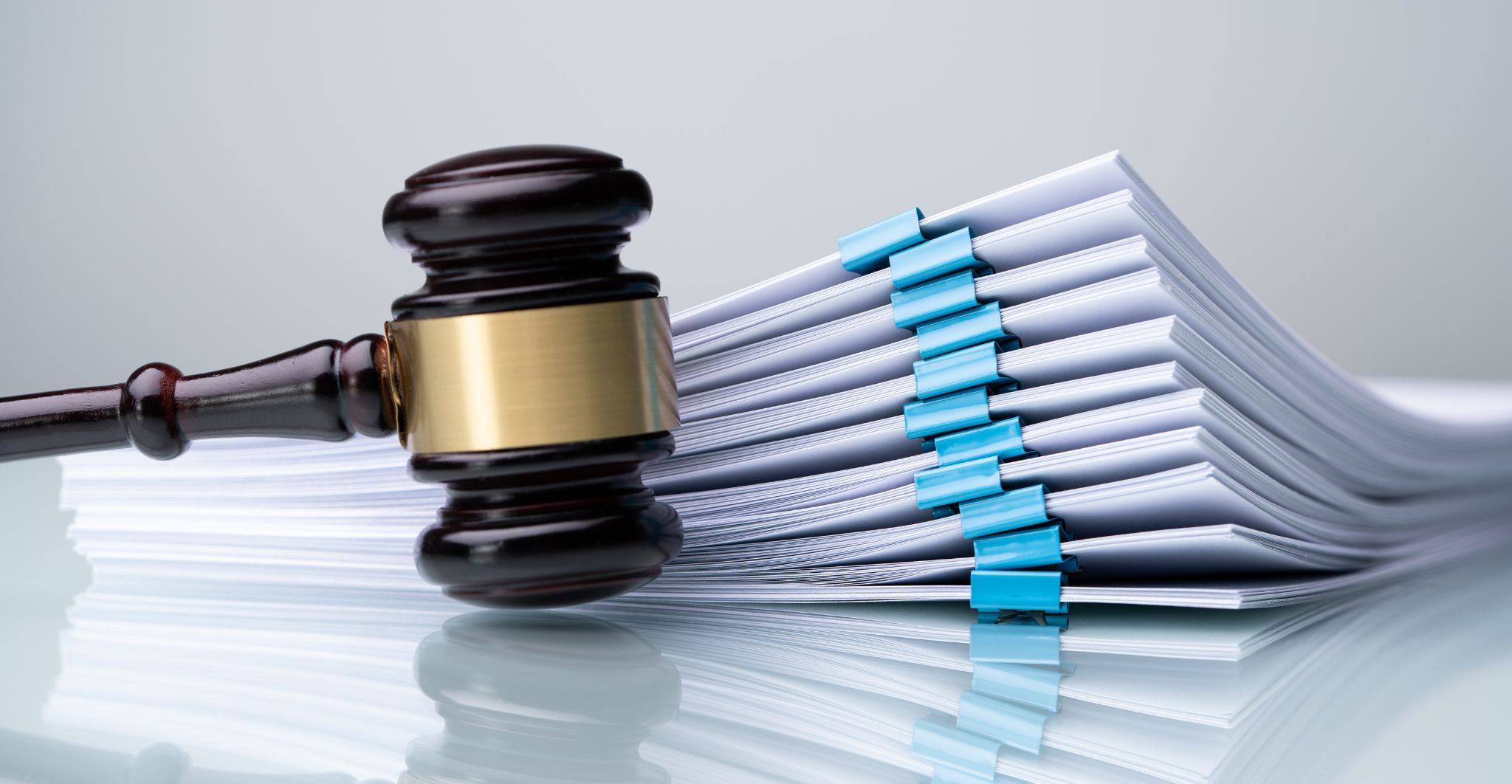 Judge's gavel with legal document bundles representing judicial review solicitors and High Court challenges to public body decisions