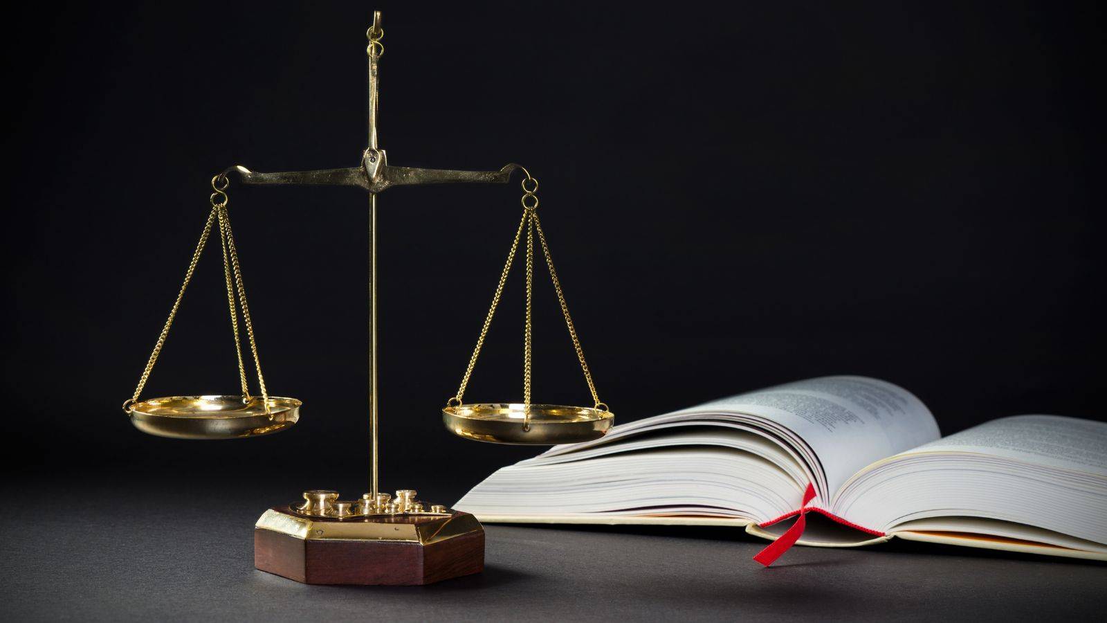 Scales of justice and open law book representing UK visa administrative review 2025 expert legal services for correcting Home Office case working errors