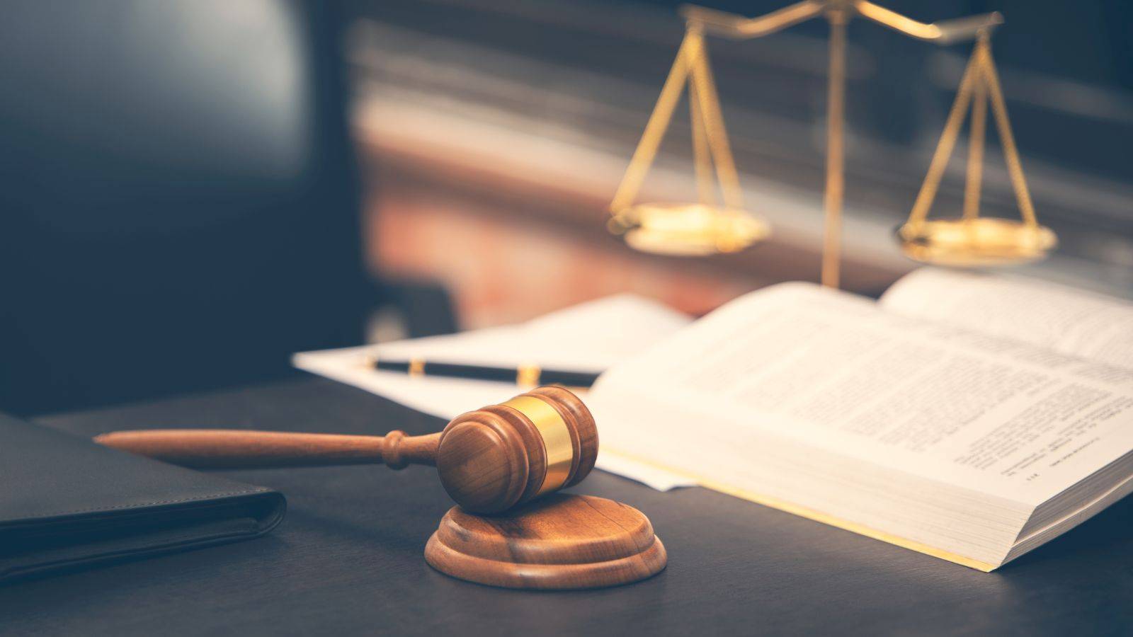 Judge's gavel and scales of justice with legal documents representing immigration judicial review solicitors UK 2025 challenging Home Office decisions