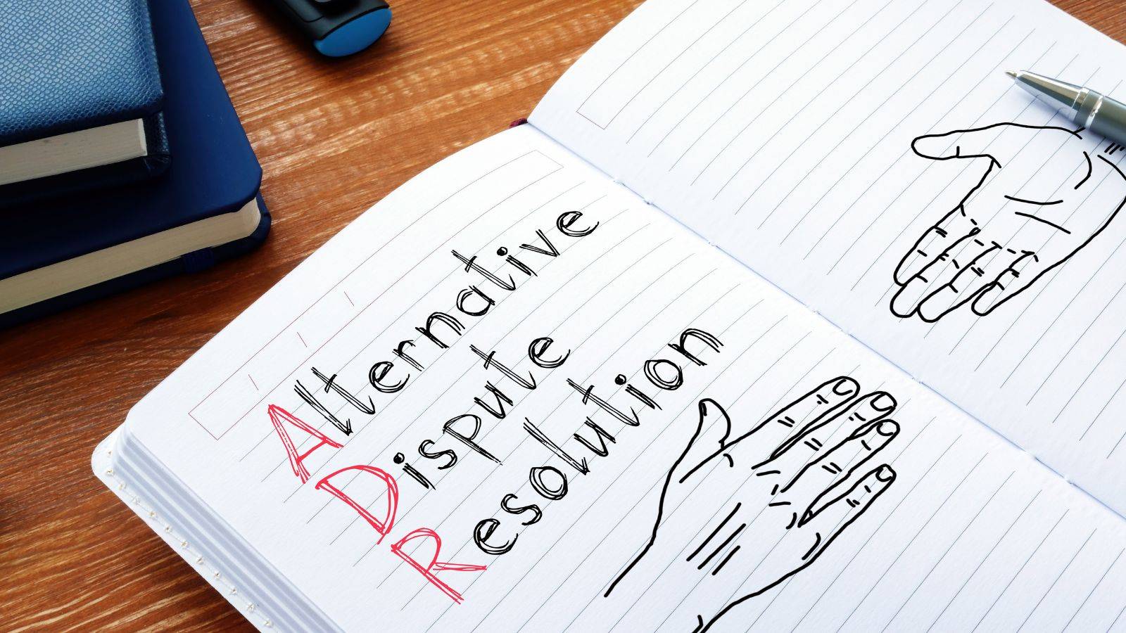 Hand-written alternative dispute resolution planning notebook with sketches showing collaborative ADR approach for UK legal services 2025