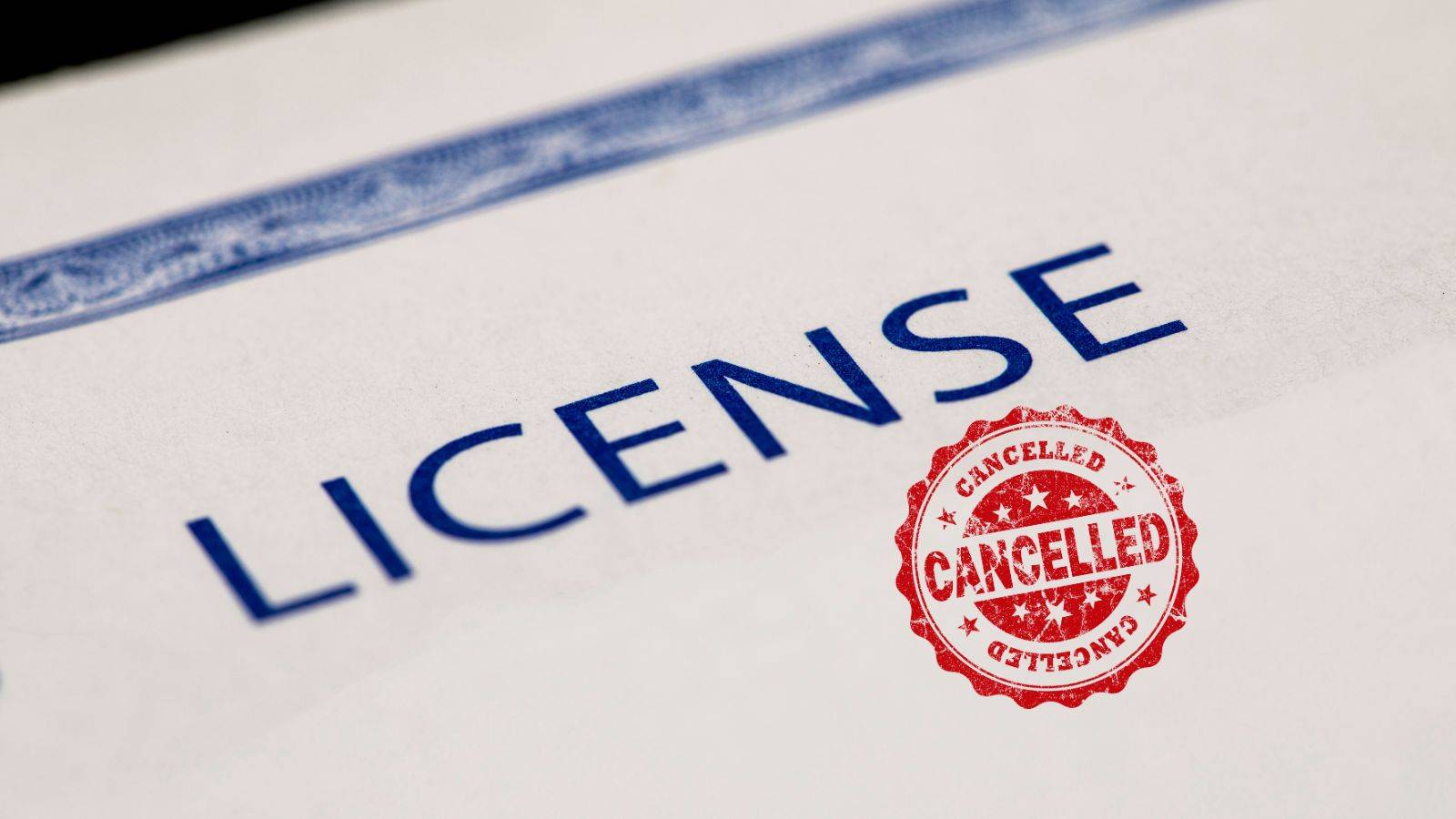 Official sponsor licence document with red CANCELLED stamp representing UK sponsor licence revocation solicitors 2025 legal defence services