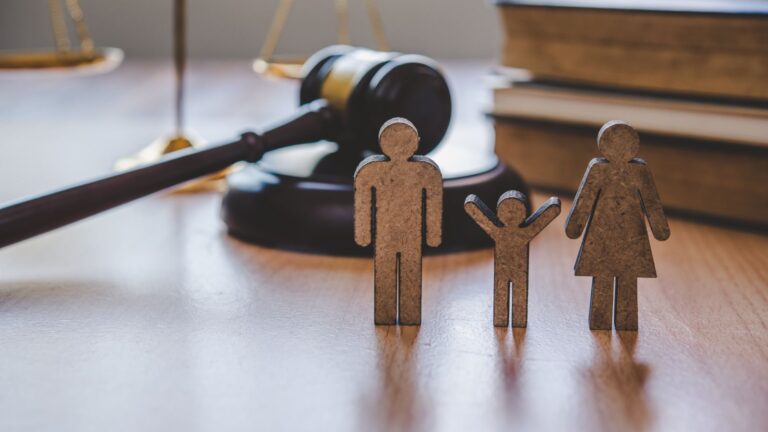 Legal gavel with wooden family figures representing EU Settlement Scheme family members 2025 legal proceedings