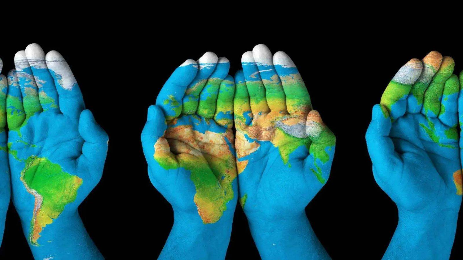 Multiple hands holding world globes representing global citizenship lawyers UK 2025 second citizenship consultation services