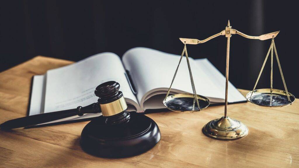 Immigration tribunal gavel and scales with open law book representing immigration appeals solicitors UK 2025 expert representation