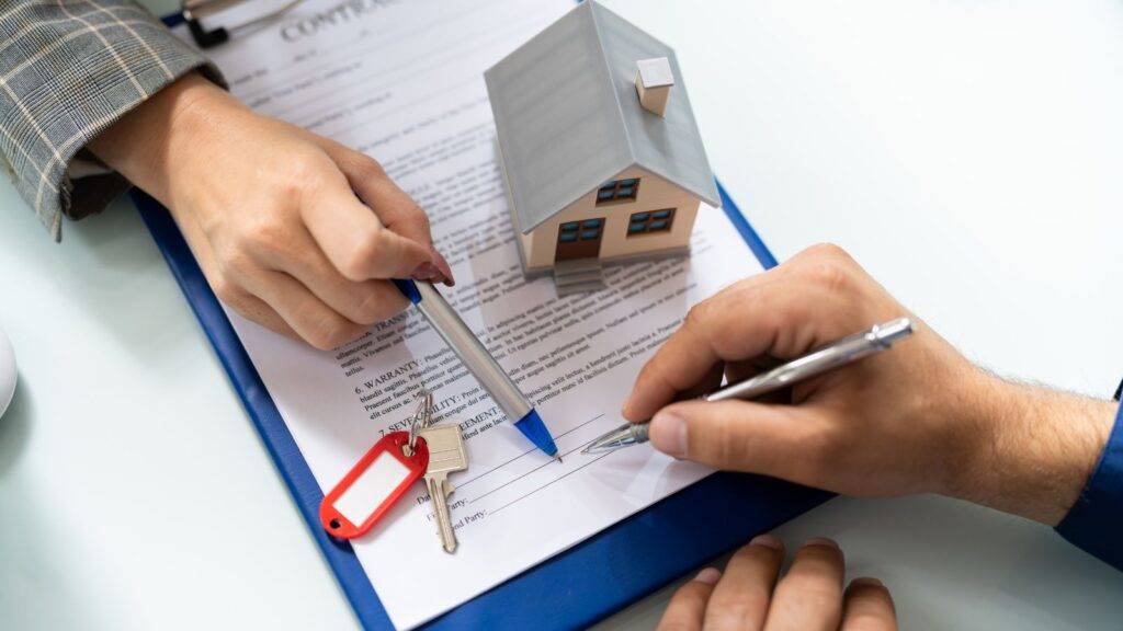 Lease extension calculator UK 2025 – signing a lease agreement with house model and keys on document
