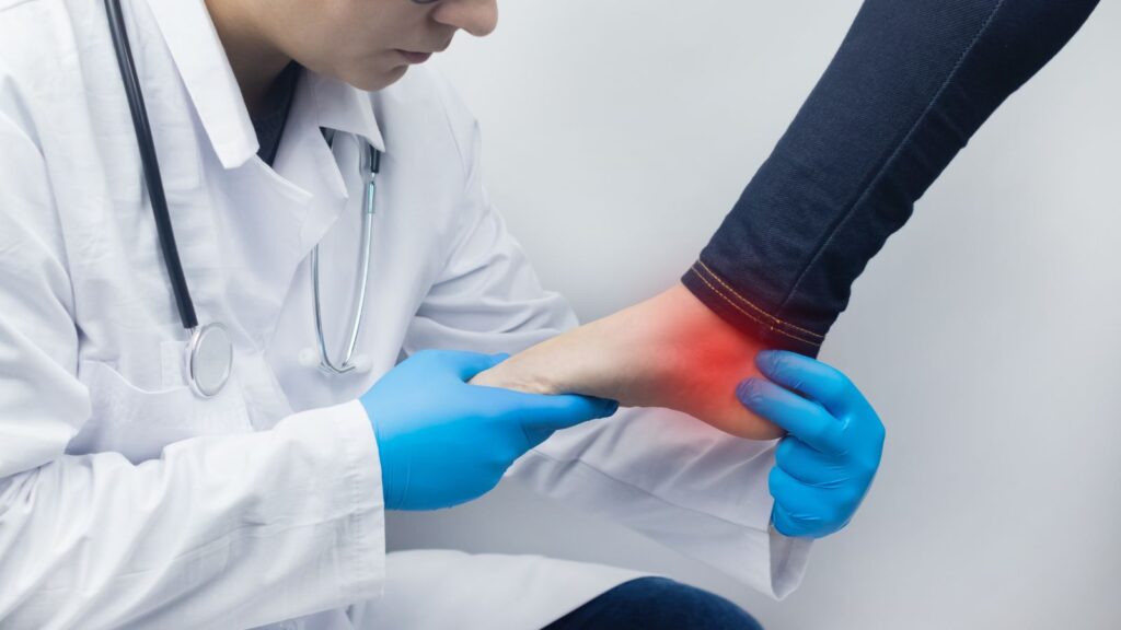 Doctor examining foot injury with stethoscope representing foot injury claim calculator UK 2025 medical assessment