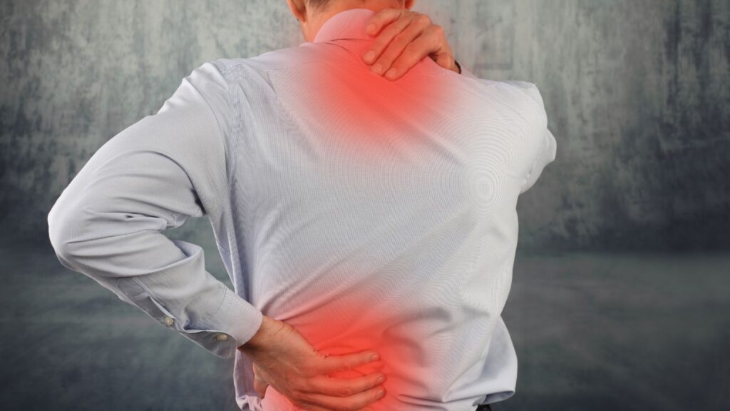 Person experiencing neck and back pain from whiplash injury relevant to whiplash injury claim calculator UK 2025