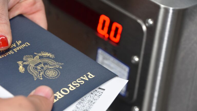 Passport being digitally scanned at border control representing enhanced immigration enforcement monitoring systems introduced in UK immigration enforcement white paper 2025
