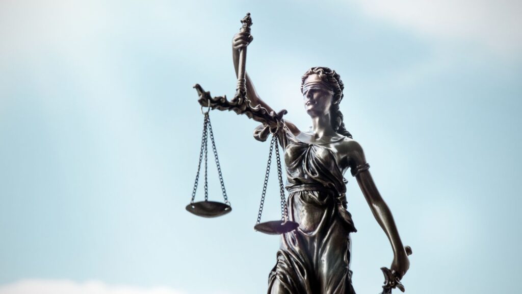 Lady Justice statue with scales and blindfold representing UK civil litigation history 1873-2025 showing 152 years of legal evolution from Judicature Acts to modern digital courts