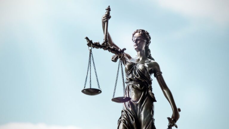 Lady Justice statue with scales and blindfold representing UK civil litigation history 1873-2025 showing 152 years of legal evolution from Judicature Acts to modern digital courts