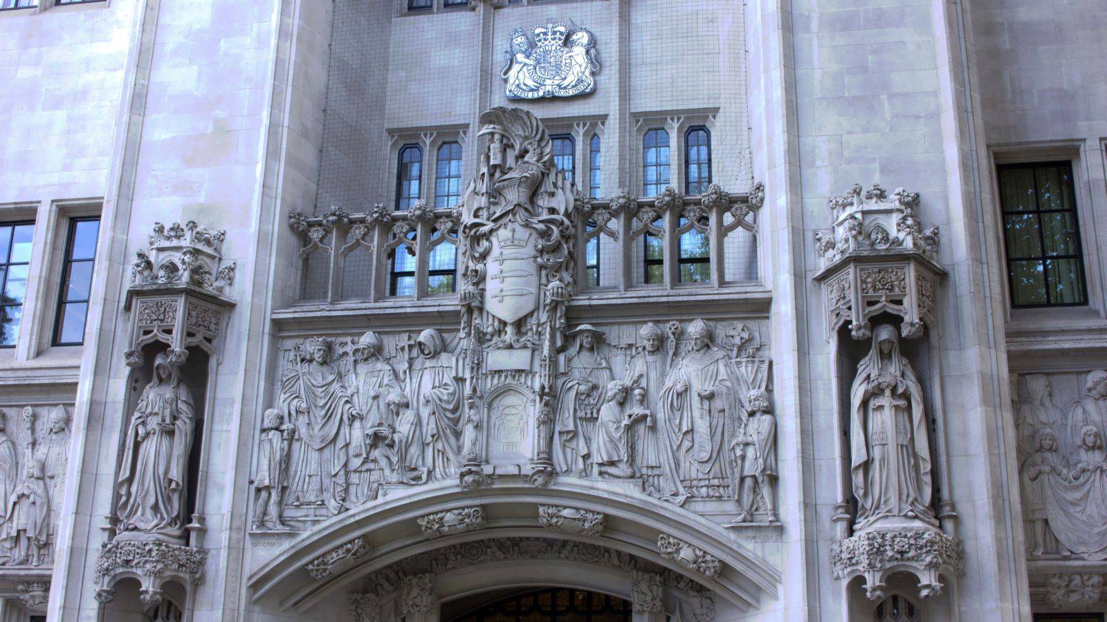 UK Supreme Court building facade with royal coat of arms representing UK deportation appeals 2025 legal analysis