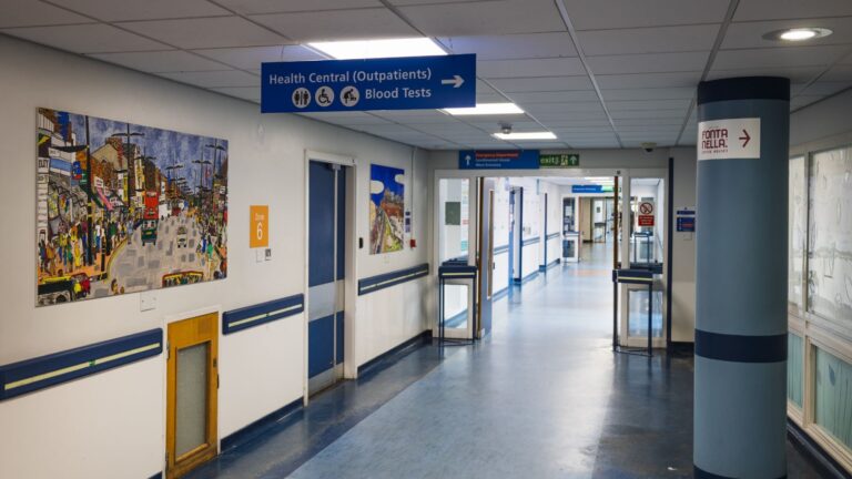 Modern London hospital corridor with medical signage representing medical visitor visa UK requirements 2025 healthcare facilities