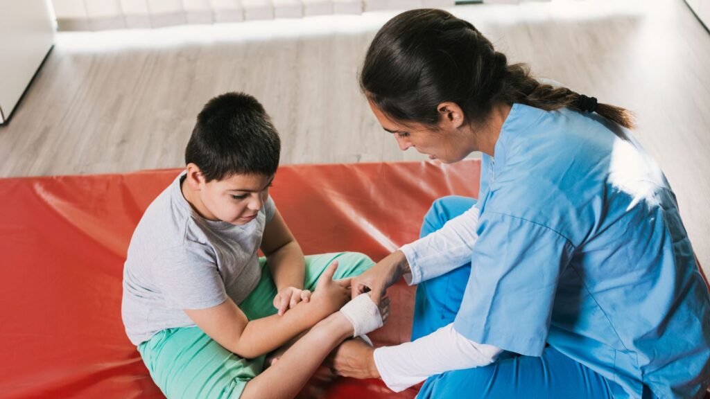 Medical professional treating child's arm injury representing child injury compensation claims UK 2025 legal assessment