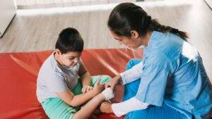Medical professional treating child's arm injury representing child injury compensation claims UK 2025 legal assessment