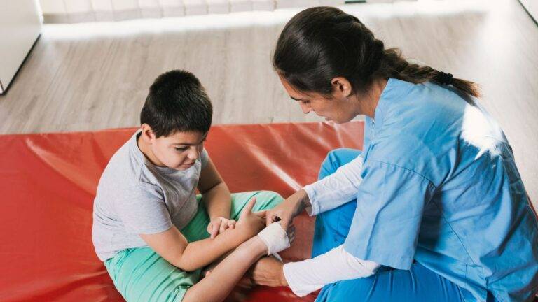 Medical professional treating child's arm injury representing child injury compensation claims UK 2026 legal assessment