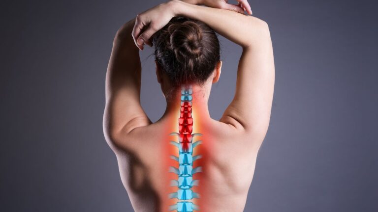 Posterior view woman with color-coded spine showing red cervical neck pain and red lumbar lower back pain with blue thoracic spine representing back injury compensation claims UK 2025 injury assessment zones