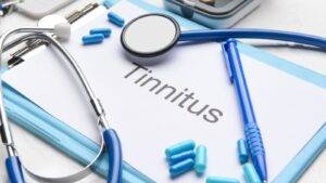 Medical diagnostic clipboard displaying tinnitus assessment form with stethoscope and clinical equipment representing tinnitus compensation UK 2025 legal claims