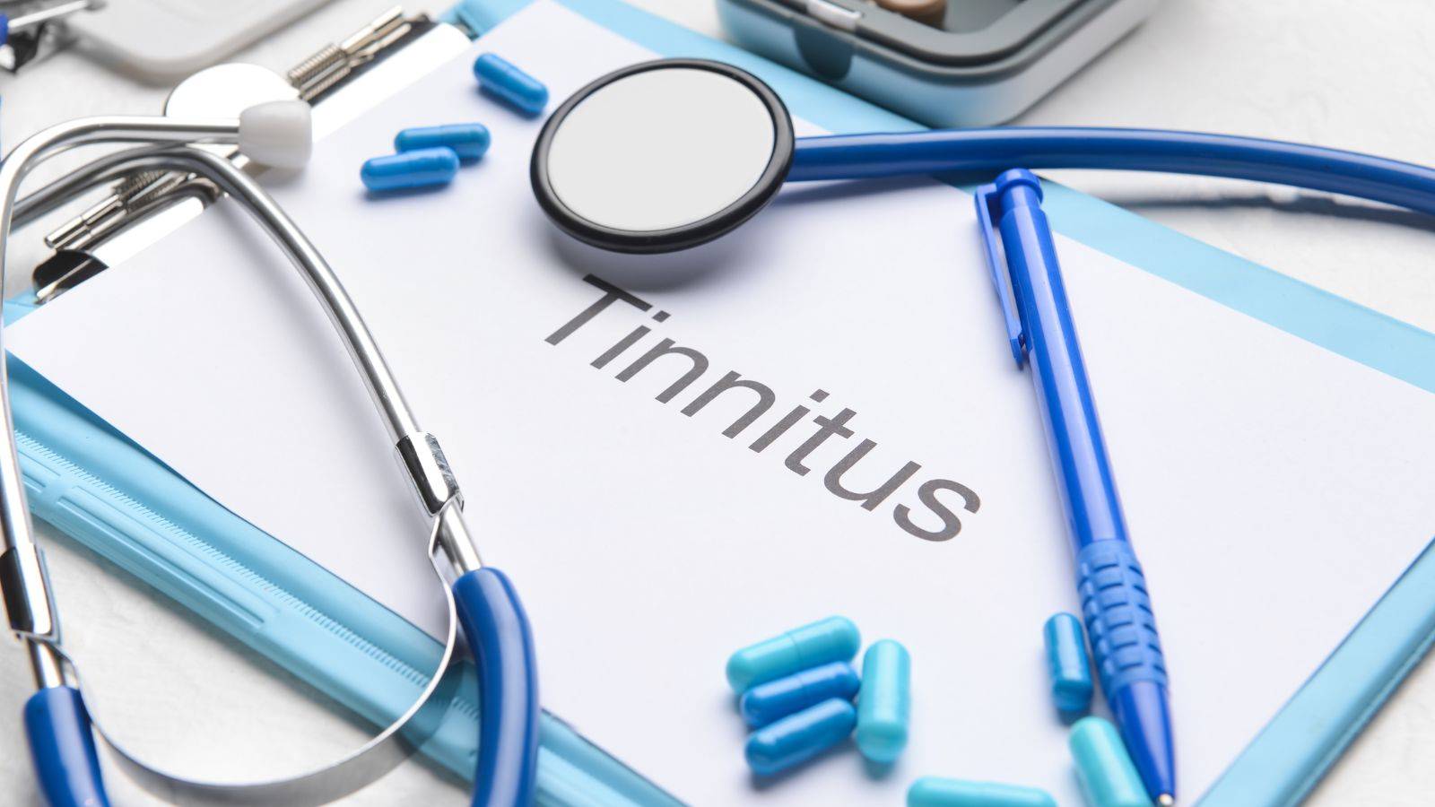 Medical diagnostic clipboard displaying tinnitus assessment form with stethoscope and clinical equipment representing tinnitus compensation UK 2025 legal claims
