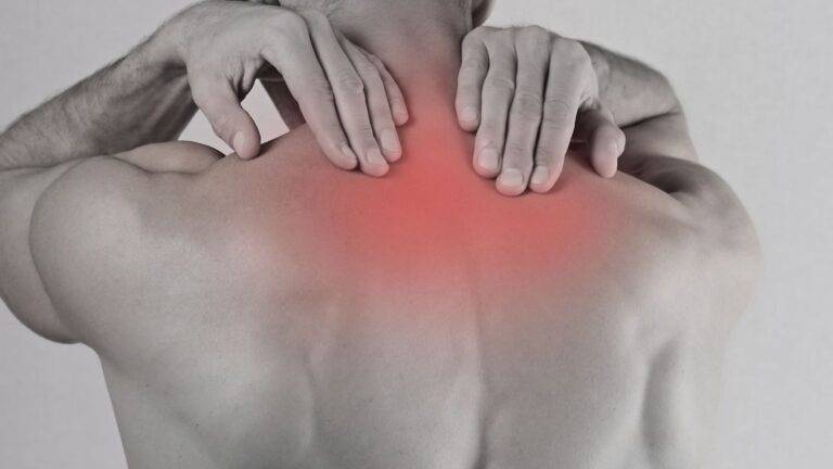 Back pain injury illustration showing whiplash payout scale UK 2026 compensation assessment areas