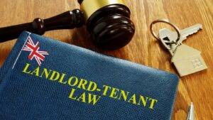 Landlord-tenant law book with legal gavel house keys and UK flag representing tenant rights during eviction UK 2025
