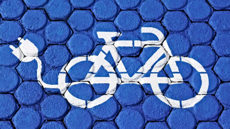 E-Bike Symbol With Electric Plug Painted On Blue Hexagonal Paving Representing E-Bike Accident Claims Uk 2026 Legal Frameworks