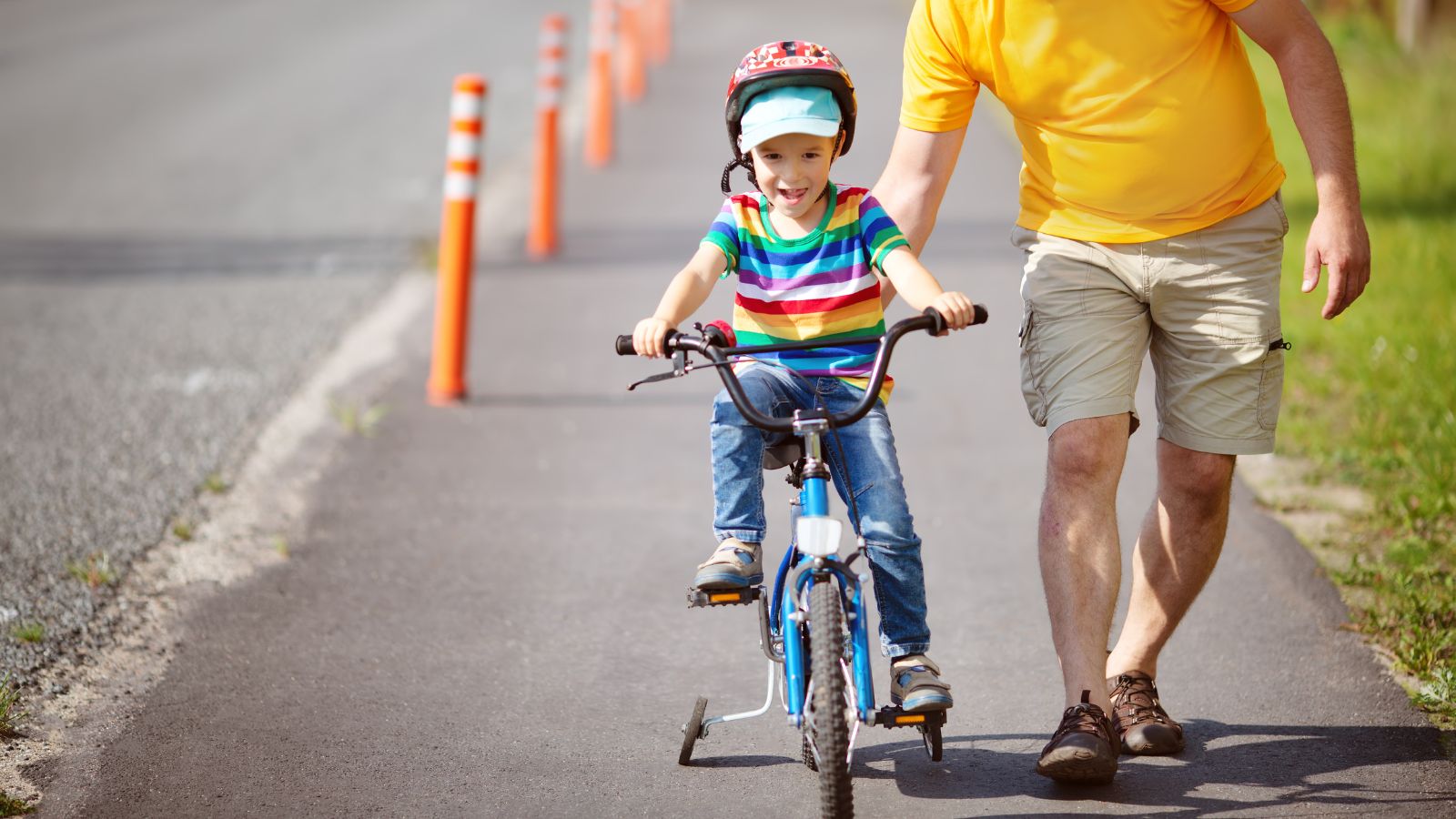 Parent guiding young child wearing helmet on bicycle in residential street representing child cycling accident claims UK 2026 litigation friend parental protection and legal rights