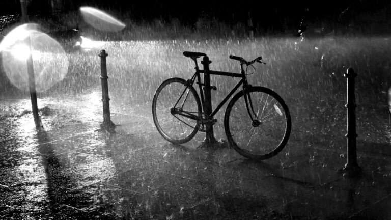Lone Bicycle Abandoned In Heavy Rain At Night Representing Hit And Run Cycling Accident Claim Uk 2026 Aftermath Where Drivers Flee The Scene Leaving Cyclists Without Immediate Support